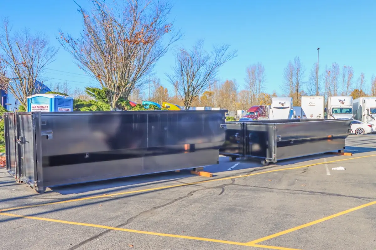 Professional dumpster rental service with roll-off container on residential driveway in Eastlake